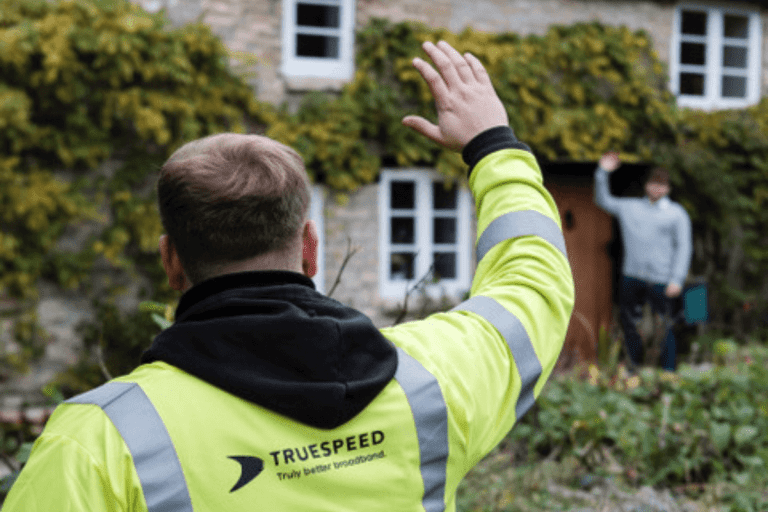 A Truespeed engineer waves to a customer after connecting them to our ultrafast broadband network